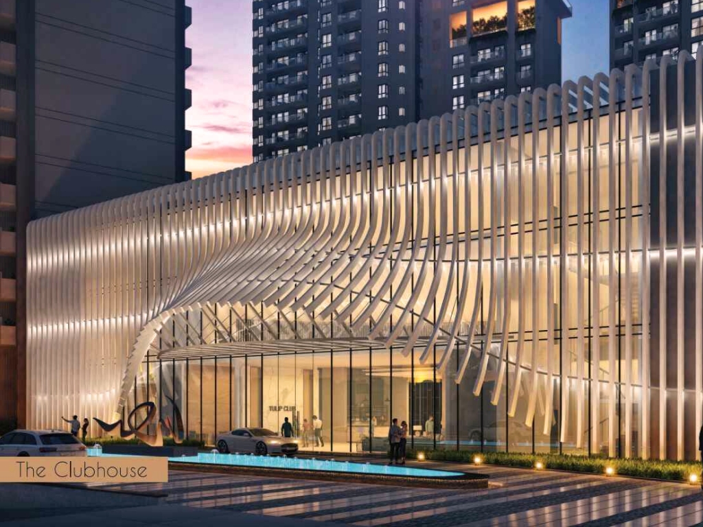 The exterior view of the club house of Tulip Monsella Gurgaon has a modern architecture / design look through its glass façade and illuminates its vertical fins along Golf Course Road.