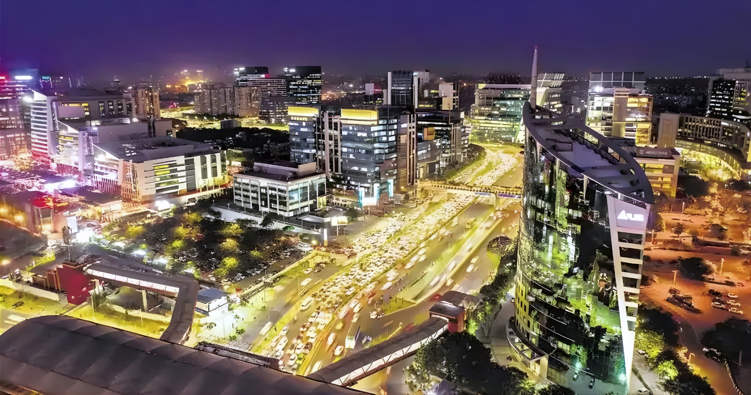 Night view of South City II Gurgaon with illuminated commercial buildings, busy roads, and premium urban infrastructure in one of the posh areas in Gurgaon.