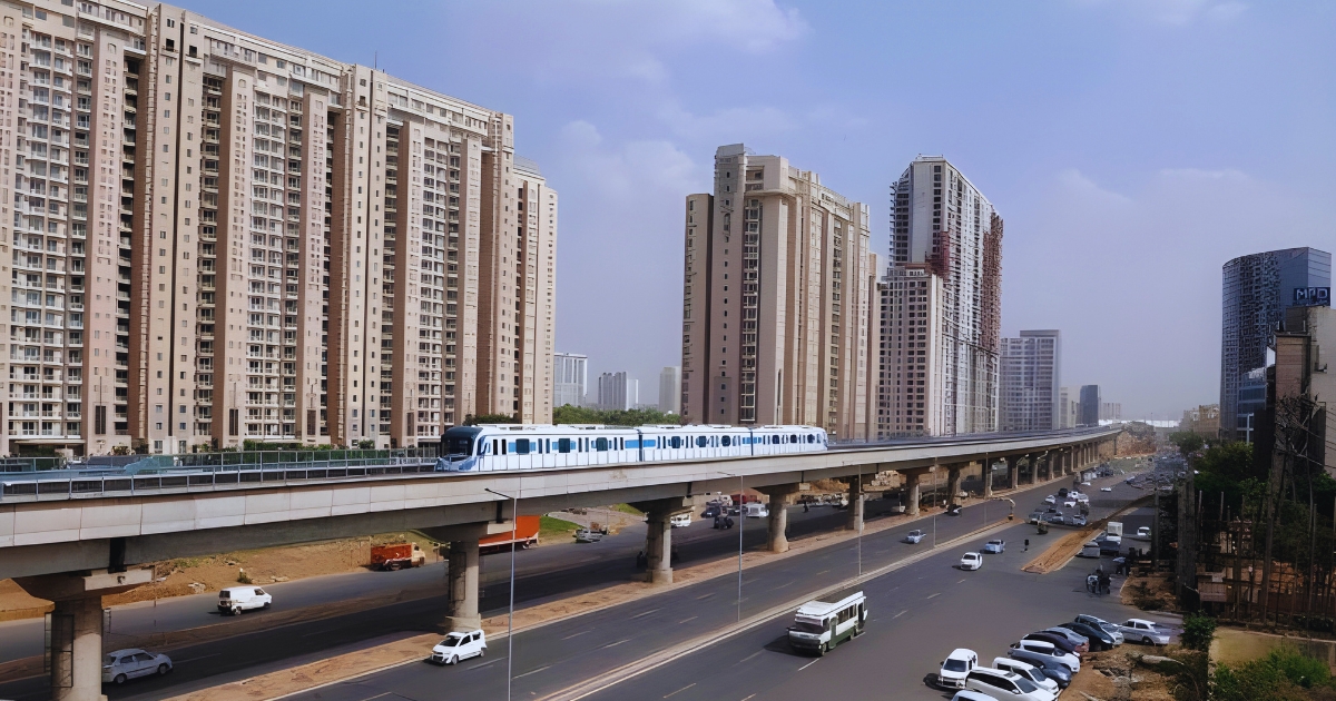 Tall luxury residential towers with a metro line along Golf Course Road, highlighting why it ranks among the posh areas in Gurgaon.