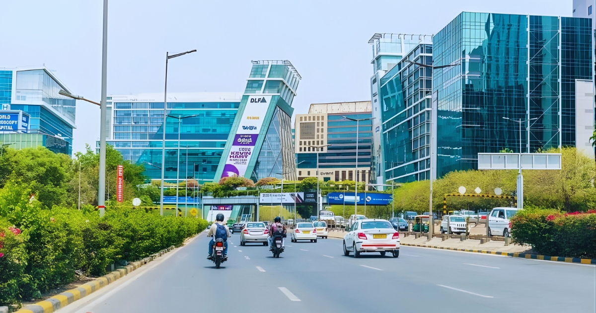 Roadside view of DLF Cyber City with modern glass office buildings, showcasing high-end infrastructure in one of the posh areas in Gurgaon.