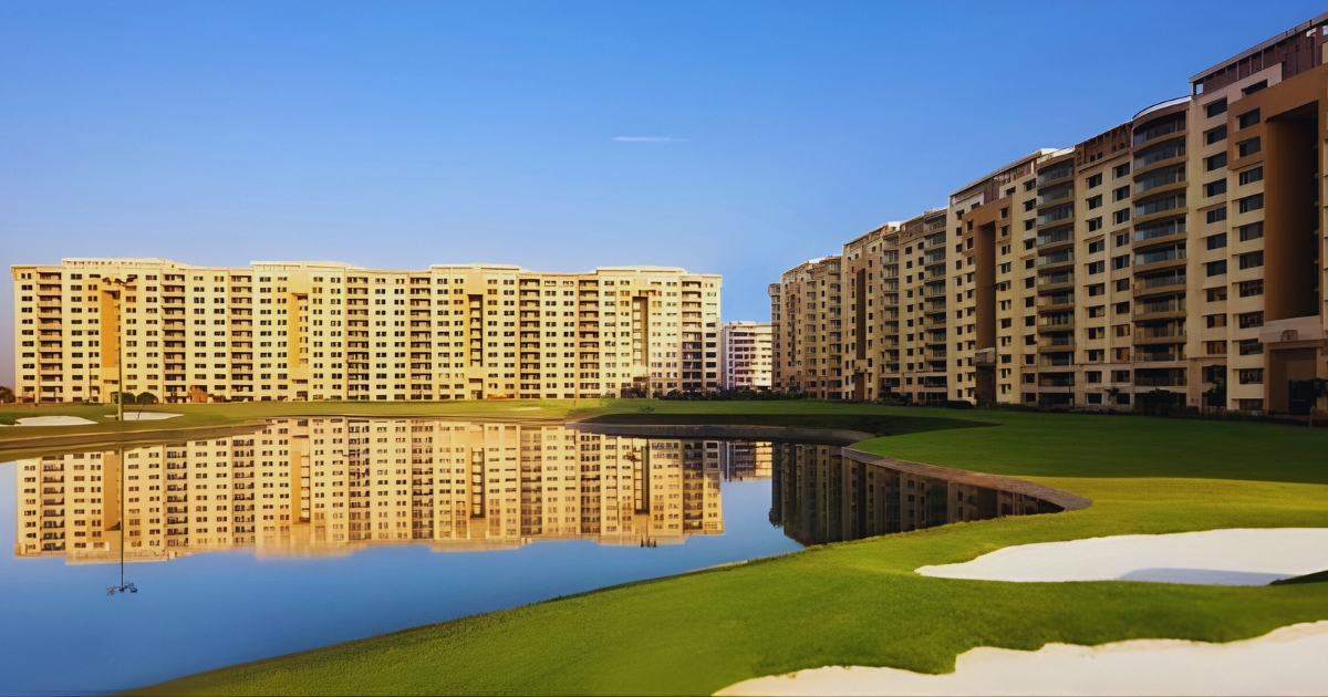 Waterfront luxury apartments in Ambience Island Gurgaon with a serene lake and landscaped surroundings in a posh residential area.