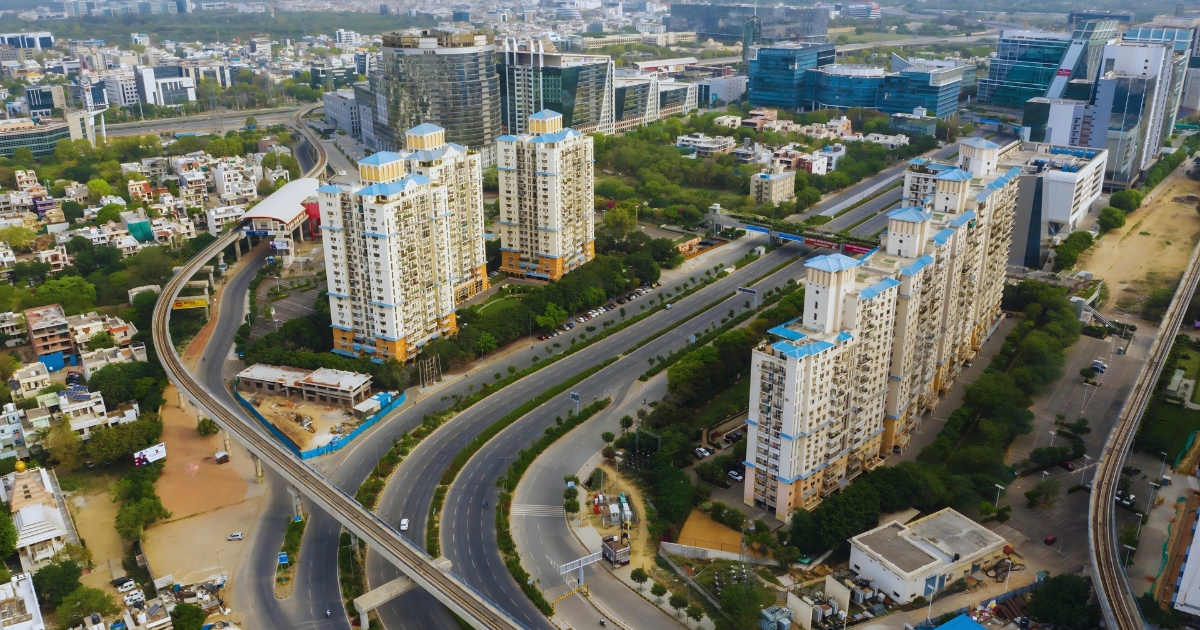 Aerial view of DLF City Phases 1–5 in Gurgaon showing luxury high-rise apartments, metro connectivity, and green surroundings in one of the posh areas in Gurgaon.